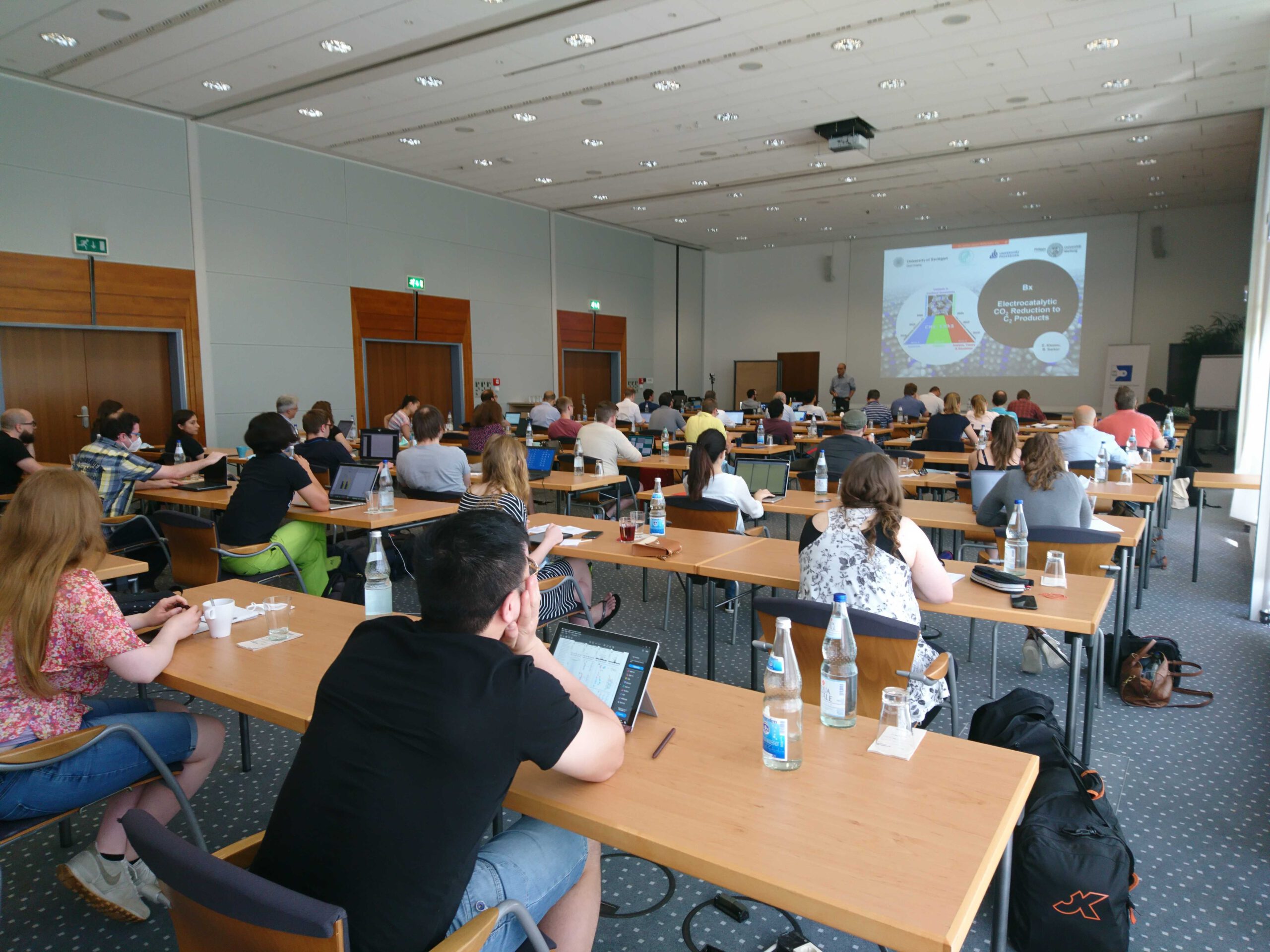 Doctoral Researcher of the CRC1333 sitting in a row watching a presentation on the screen